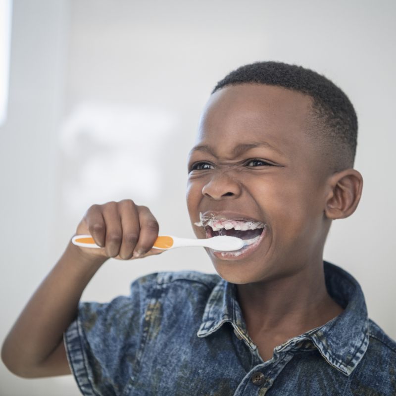 Criança escovando os dentes